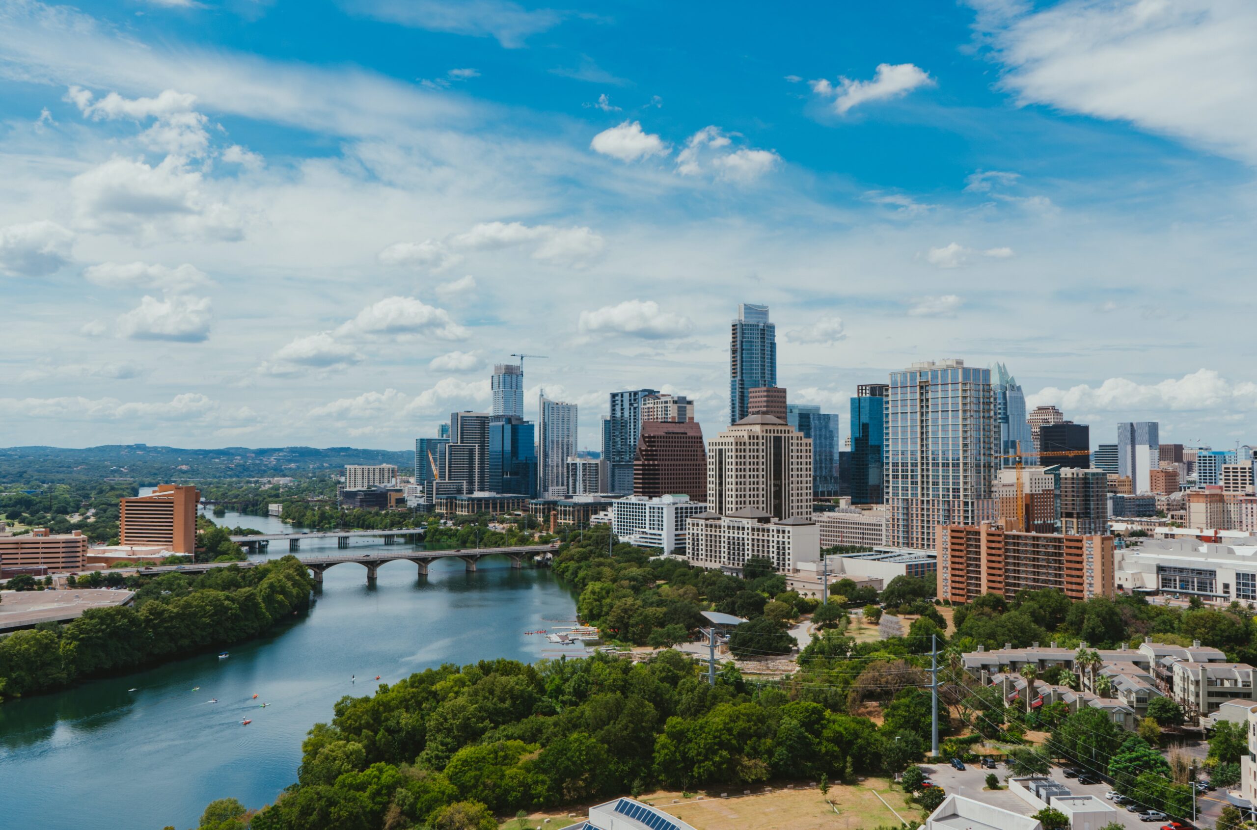 A photo of the Austin skyline with the buildings colored a beautiful pinkish hue from the sunset. It is connected to a blog about 7 reasons to pickup trash in Austin, Texas.