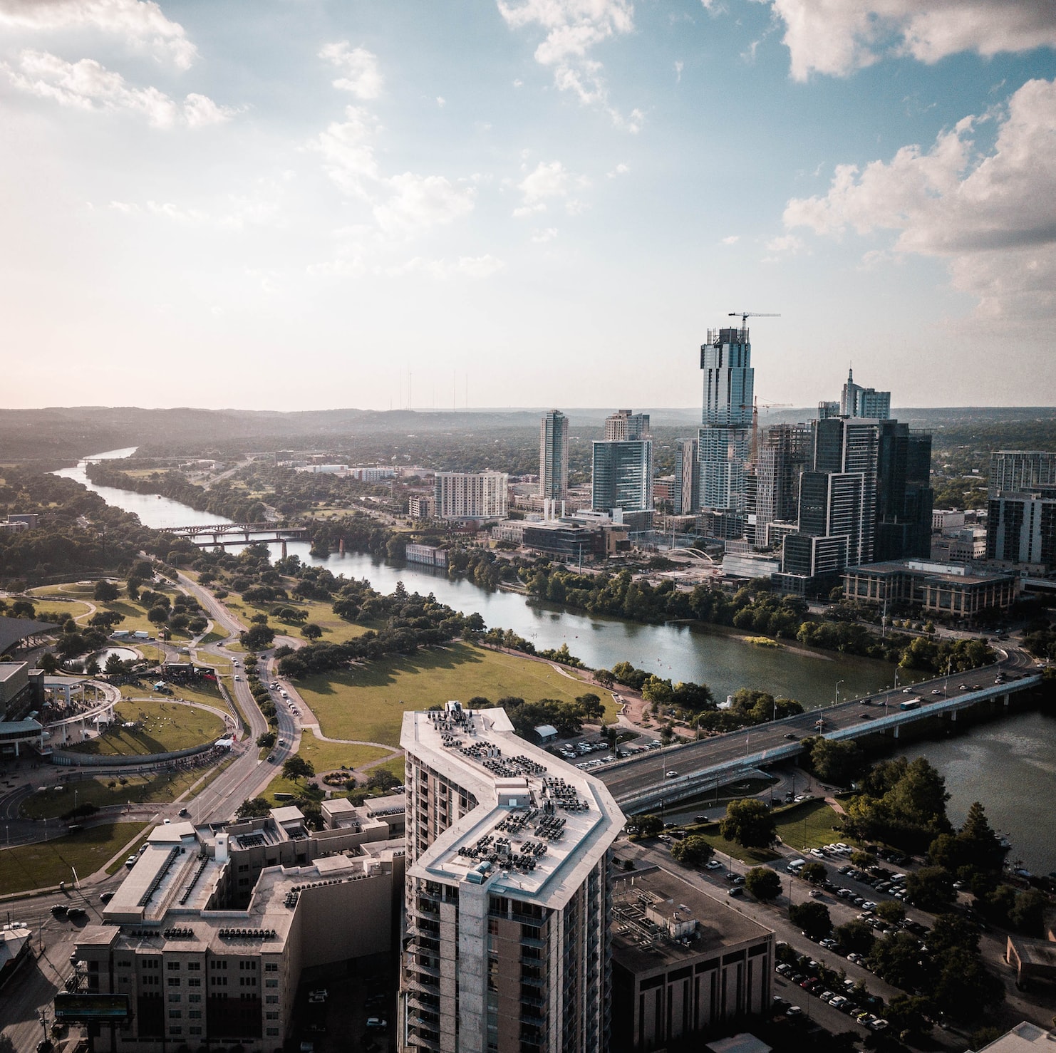 A photo of the Austin skyline with the buildings colored a beautiful pinkish hue from the sunset. It is connected to a blog about 7 reasons to pickup trash in Austin, Texas.