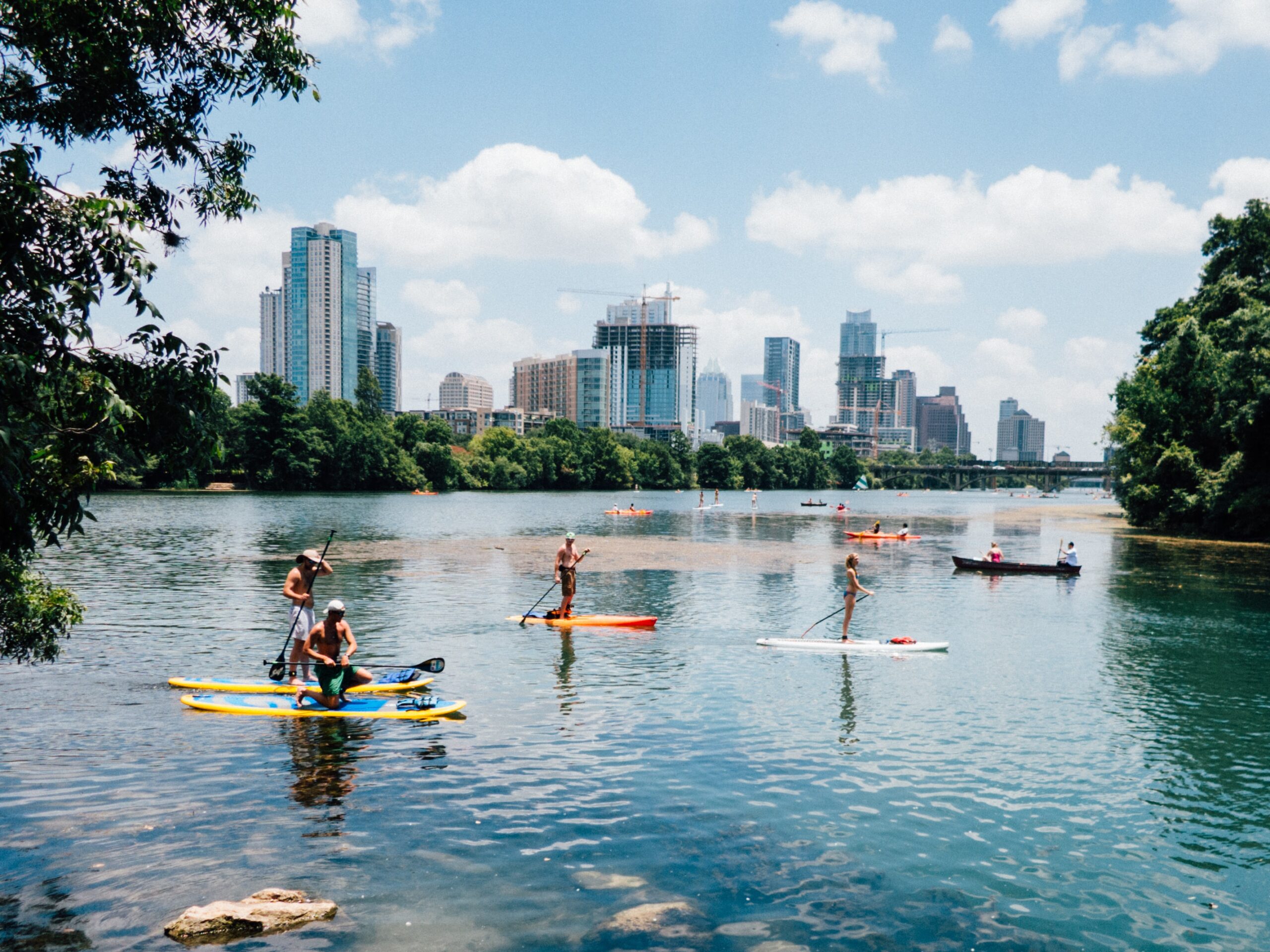 A photo of the Austin skyline with the buildings colored a beautiful pinkish hue from the sunset. It is connected to a blog about 7 reasons to pickup trash in Austin, Texas.